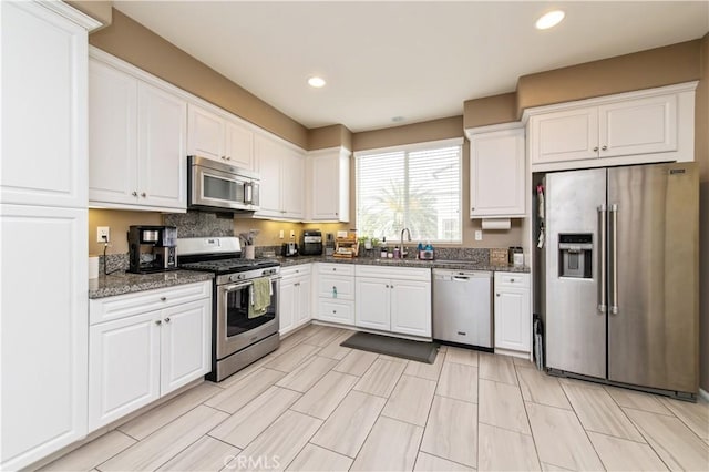 12440 Constellation St, Eastvale, CA 91752 - kitchen with appliances with stainless steel finishes, a sink, white cabinetry, and recessed lighting