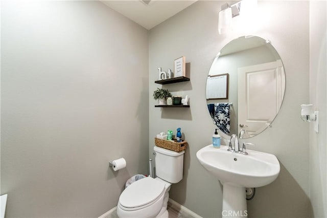 12440 Constellation St, Eastvale, CA 91752 - bathroom featuring toilet, baseboards, and a sink