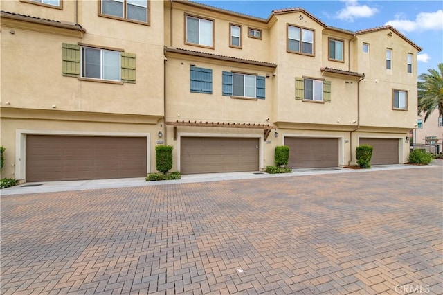 12440 Constellation St, Eastvale, CA 91752 - townhome / multi-family property featuring a garage, stucco siding, and driveway