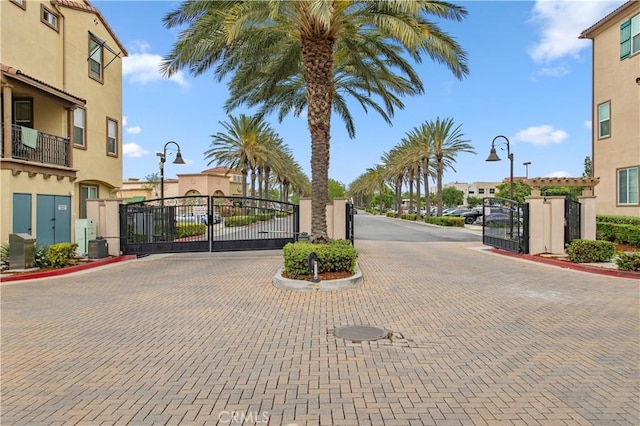 12440 Constellation St, Eastvale, CA 91752 - view of decorative street with a gate, street lights, and curbs