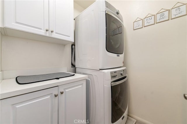 12440 Constellation St, Eastvale, CA 91752 - laundry room with stacked washer / dryer, cabinet space, and baseboards