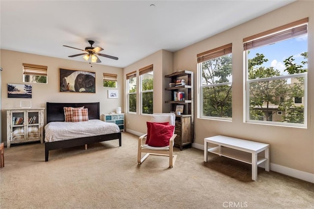 bedroom with carpet flooring, baseboards, and a ceiling fan