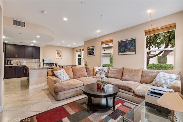 living area with light tile patterned flooring, healthy amount of natural light, and recessed lighting