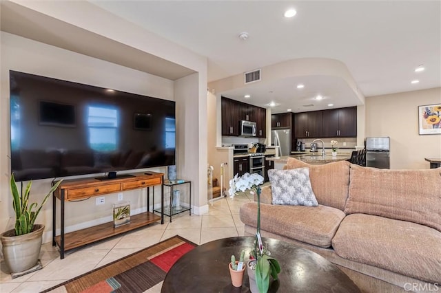 living area with light tile patterned floors, recessed lighting, and baseboards