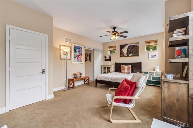 carpeted bedroom featuring baseboards, ceiling fan, and a closet