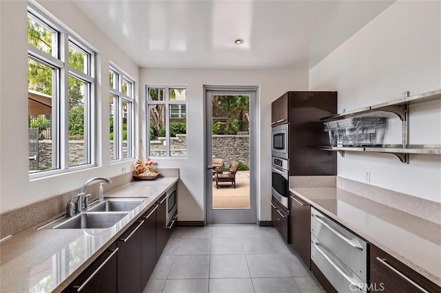 kitchen with appliances with stainless steel finishes, healthy amount of natural light, modern cabinets, and a sink