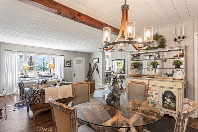 dining space featuring a chandelier, wood finished floors, a decorative wall, and wood ceiling