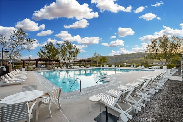 community pool featuring a pergola and a patio area