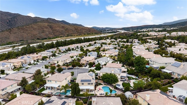 aerial perspective of suburban area featuring mountains and a pool