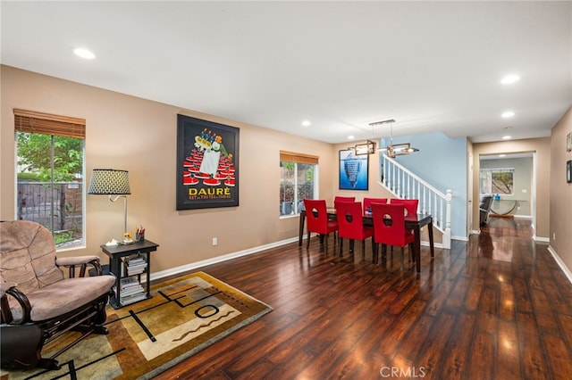dining room with hardwood / wood-style floors, stairs, baseboards, recessed lighting, and a chandelier