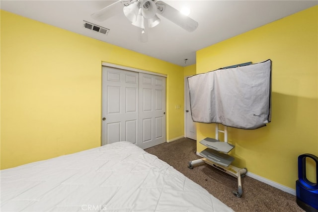 carpeted bedroom featuring a closet, ceiling fan, and baseboards