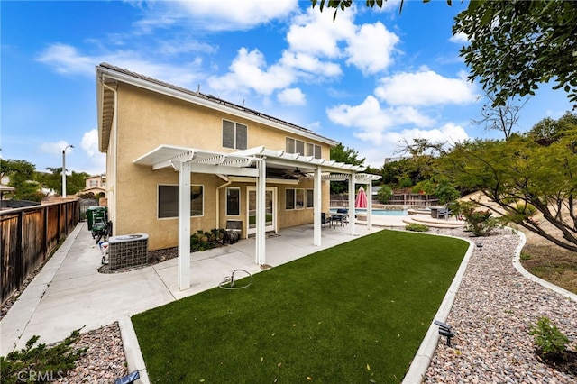 rear view of house featuring a pergola, cooling unit, stucco siding, a patio, and a ceiling fan