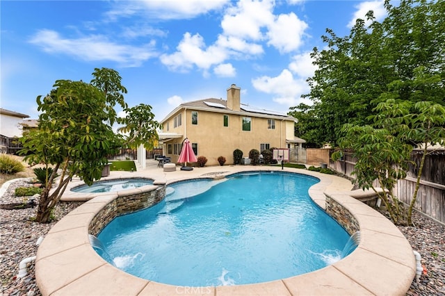 view of pool with a fenced backyard, a patio area, and a pool with connected hot tub