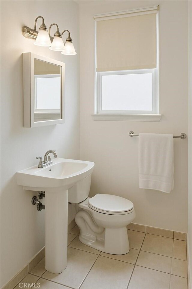 1600 N Hobart Blvd Unit 16, Los Angeles, CA 90027 - half bathroom featuring tile patterned floors, toilet, and baseboards