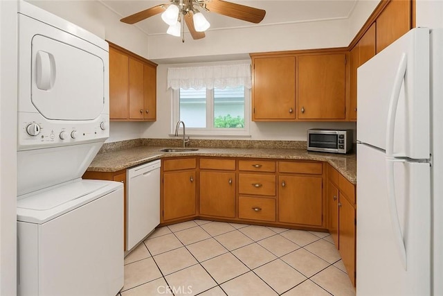 1600 N Hobart Blvd Unit 16, Los Angeles, CA 90027 - kitchen featuring white appliances, a sink, estacked washer and dryer, a ceiling fan, and brown cabinets