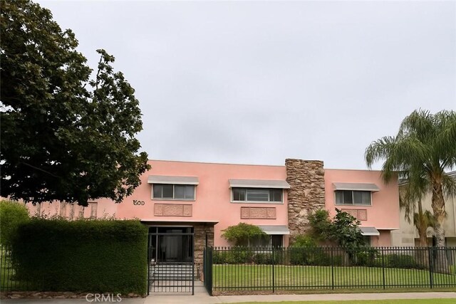 1600 N Hobart Blvd Unit 16, Los Angeles, CA 90027 - view of front facade featuring stucco siding, a gate, and stone siding