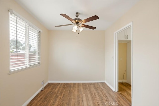 1808 W Palm Dr, West Covina, CA 91790 - spare room with wood finished floors, ceiling fan, and baseboards
