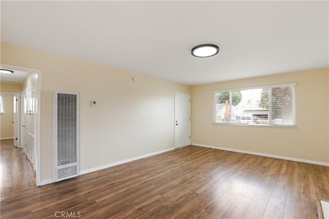 1808 W Palm Dr, West Covina, CA 91790 - unfurnished room featuring a heating unit, wood finished floors, and baseboards