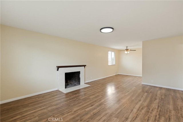 1808 W Palm Dr, West Covina, CA 91790 - unfurnished living room featuring wood finished floors, a brick fireplace, baseboards, and ceiling fan
