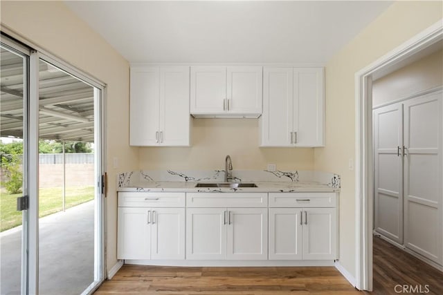 1808 W Palm Dr, West Covina, CA 91790 - kitchen featuring a sink, white cabinetry, and light stone counters