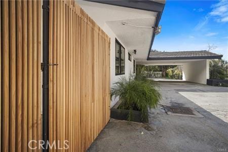 10356 Claire Ave, Porter Ranch, CA 91326 - view of side of home with concrete driveway and an attached carport