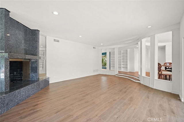 10356 Claire Ave, Porter Ranch, CA 91326 - unfurnished living room featuring wood finished floors, built in features, recessed lighting, a premium fireplace, and baseboards