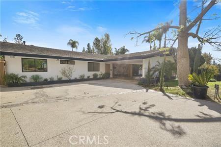 single story home with concrete driveway and stucco siding