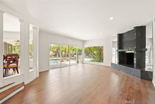 10356 Claire Ave, Porter Ranch, CA 91326 - living area featuring a high end fireplace, wood finished floors, recessed lighting, and baseboards