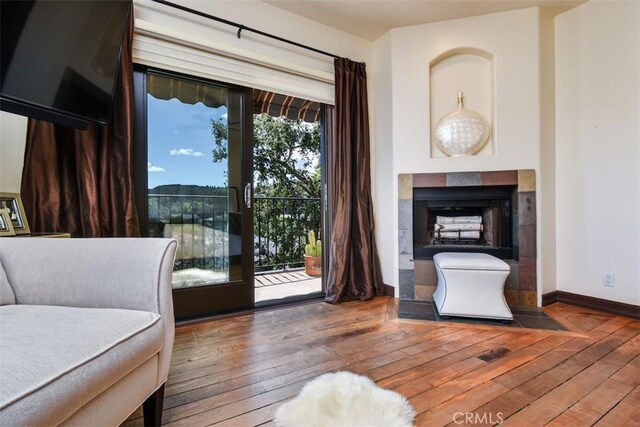 4950 Campo Rd, Woodland Hills, CA 91364 - living room featuring hardwood / wood-style floors, baseboards, and a tiled fireplace