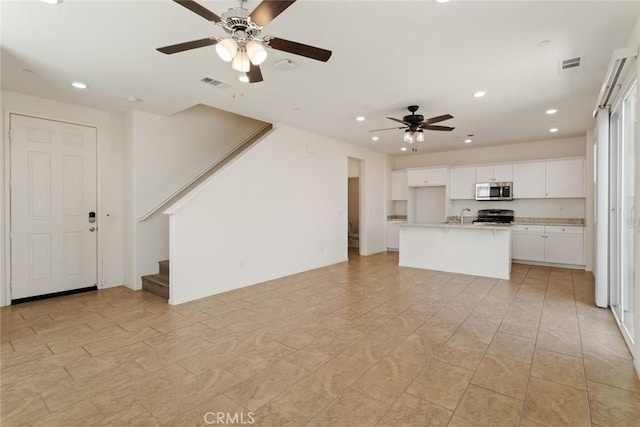 17210 Pioneer Way, San Bernardino, CA 92407 - unfurnished living room with ceiling fan, stairs, and recessed lighting