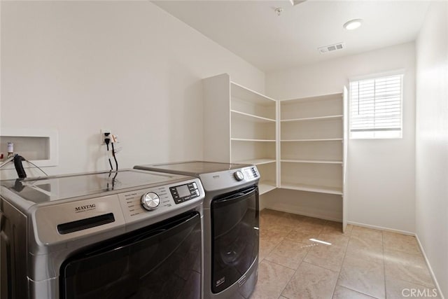 17210 Pioneer Way, San Bernardino, CA 92407 - laundry area featuring washing machine and clothes dryer and light tile patterned floors
