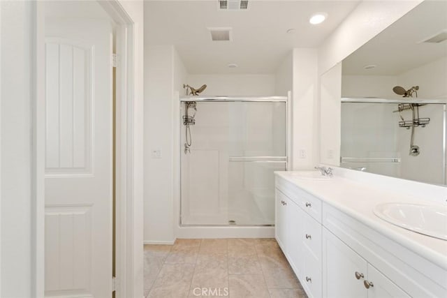 17210 Pioneer Way, San Bernardino, CA 92407 - bathroom with a stall shower, double vanity, and recessed lighting