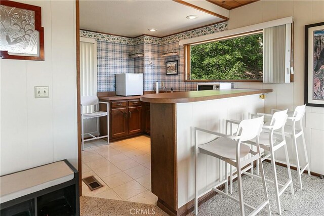 kitchen featuring a breakfast bar and recessed lighting
