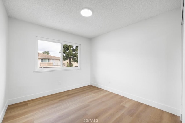 18103 Camino Bello Unit 4, Rowland Heights, CA 91748 - unfurnished room featuring a textured ceiling, light wood-style floors, and baseboards