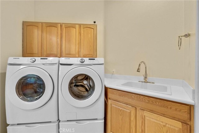 440 Brooklawn Dr, Banning, CA 92220 - washroom with cabinet space and washing machine and clothes dryer