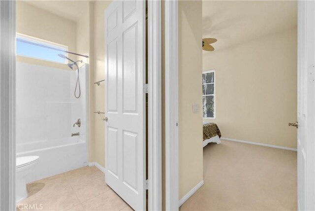 440 Brooklawn Dr, Banning, CA 92220 - full bathroom featuring toilet, baseboards, and shower / washtub combination