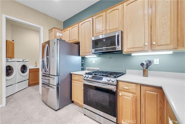 440 Brooklawn Dr, Banning, CA 92220 - kitchen with appliances with stainless steel finishes, independent washer and dryer, light brown cabinetry, and light countertops