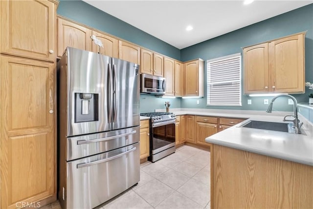 440 Brooklawn Dr, Banning, CA 92220 - kitchen with stainless steel appliances, a sink, light brown cabinets, and recessed lighting