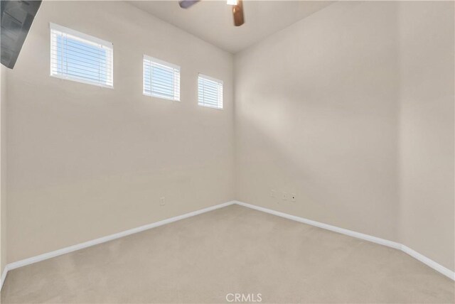 440 Brooklawn Dr, Banning, CA 92220 - spare room featuring light colored carpet, ceiling fan, and baseboards