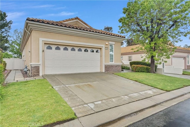 440 Brooklawn Dr, Banning, CA 92220 - mediterranean / spanish home featuring stucco siding, stone siding, concrete driveway, an attached garage, and a tile roof