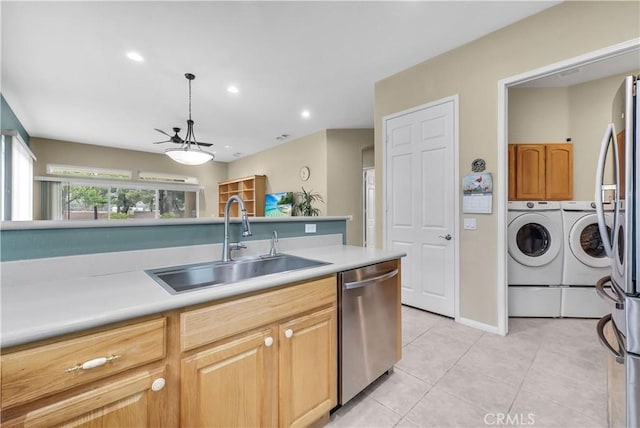 440 Brooklawn Dr, Banning, CA 92220 - kitchen with separate washer and dryer, stainless steel appliances, a sink, light tile patterned floors, and a ceiling fan