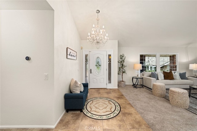 foyer entrance with a chandelier, tile patterned floors, and baseboards