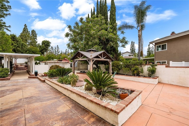 view of patio with a gazebo and fence