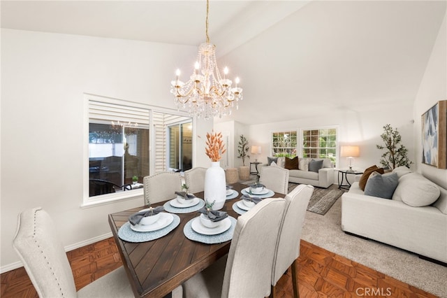 dining space featuring a chandelier, vaulted ceiling, and baseboards