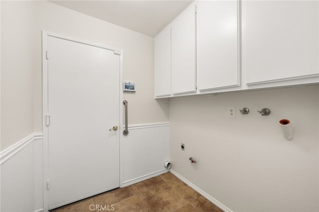 laundry room featuring gas dryer hookup, cabinet space, hookup for an electric dryer, wainscoting, and hookup for a washing machine