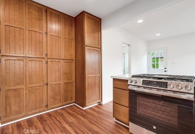 1677 252nd St, Harbor City, CA 90710 - kitchen featuring stainless steel stove, wood finished floors, brown cabinetry, recessed lighting, and light countertops