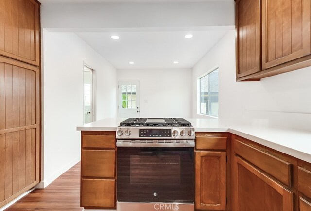 1677 252nd St, Harbor City, CA 90710 - kitchen featuring stainless steel range with gas cooktop, light wood-style flooring, a peninsula, light countertops, and recessed lighting