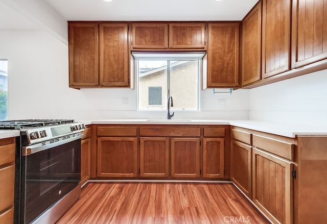 1677 252nd St, Harbor City, CA 90710 - kitchen featuring gas stove, light wood-style flooring, light countertops, and brown cabinetry