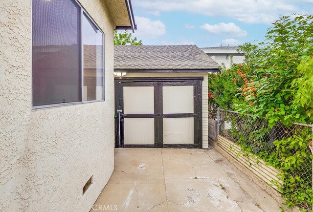 1677 252nd St, Harbor City, CA 90710 - doorway to property with a shingled roof, stucco siding, and a patio area