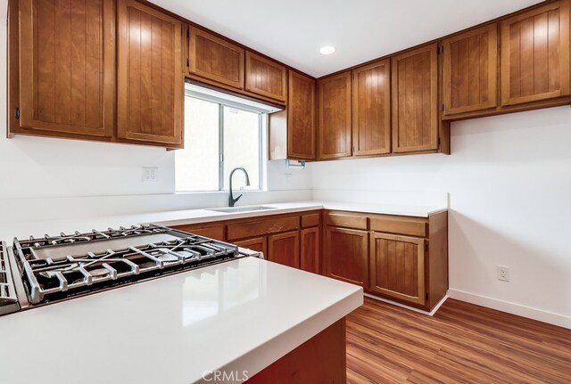 1677 252nd St, Harbor City, CA 90710 - kitchen with light wood-style floors, brown cabinets, light countertops, and recessed lighting